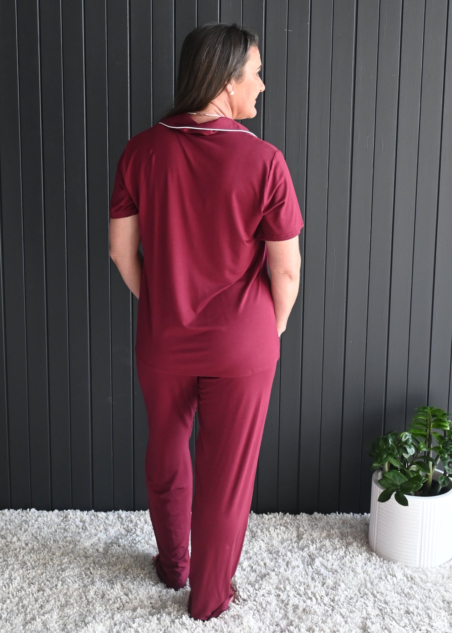 Juliette long bamboo pyjama set – model sitting comfortably with wine glass