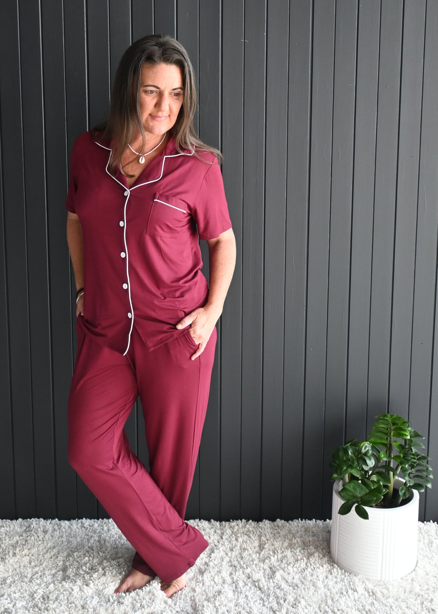 Model wearing Juliette burgundy long sleeve bamboo PJ set with white piping – front view