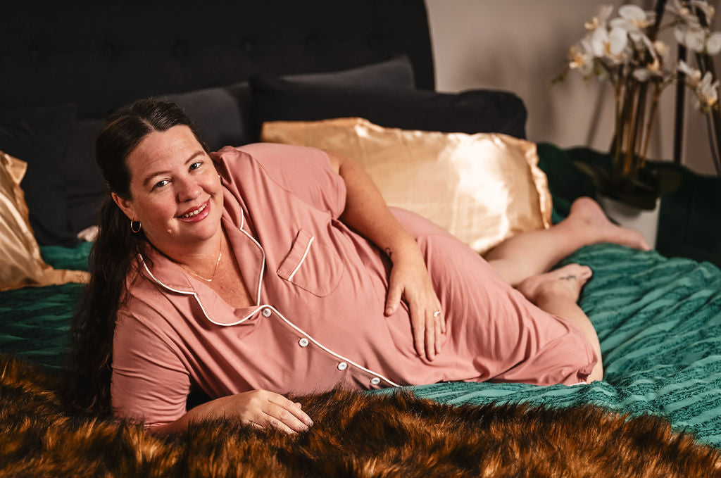 Woman lounging on bed in Georgia bamboo nightie, button-up front visible