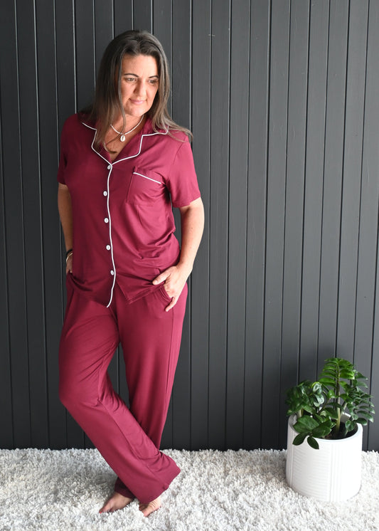 Model wearing Juliette burgundy long sleeve bamboo PJ set with white piping – front view